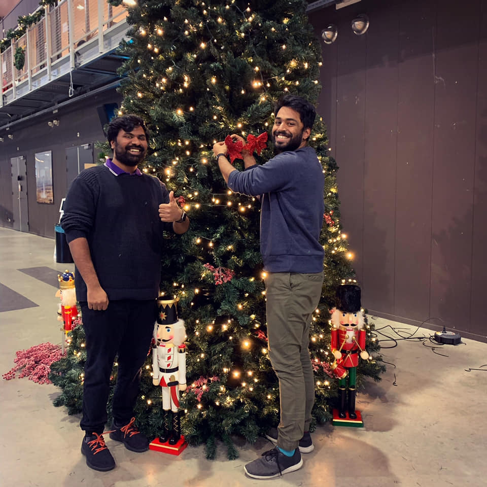 Karthik and Karthik setting up their first ever Christmas tree at the office