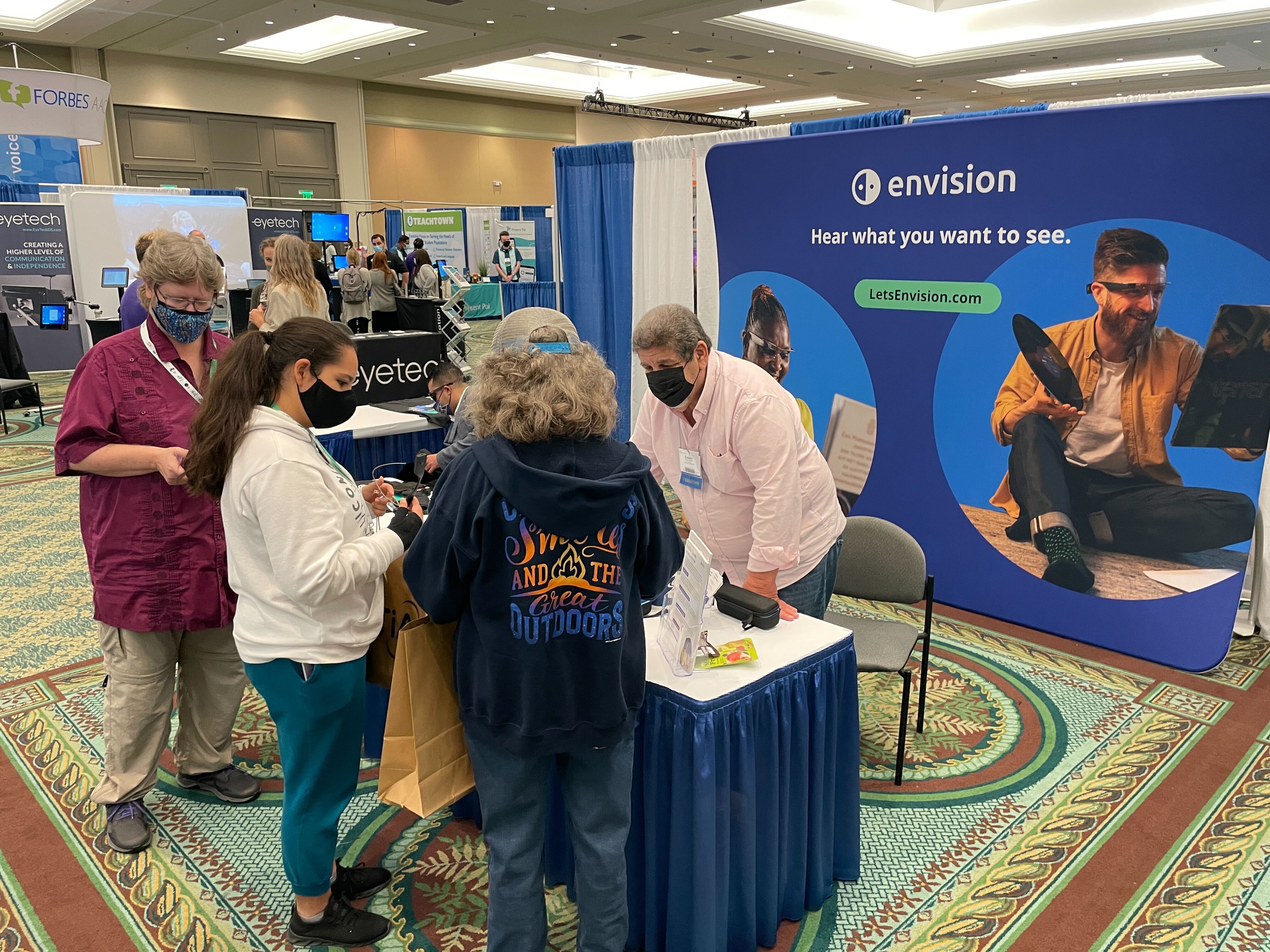 Robert from Envision speaking with a vistors at our booth