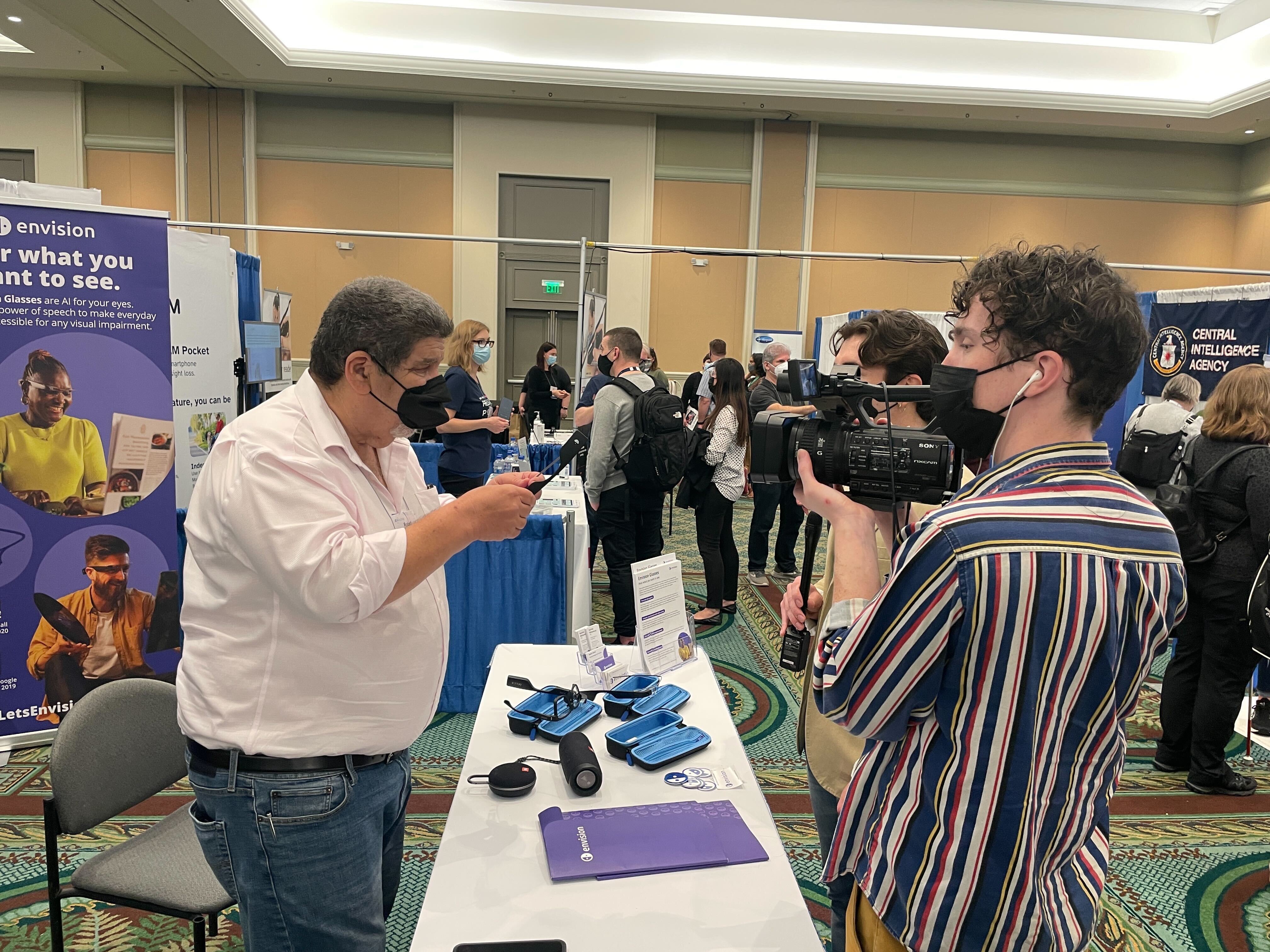 Robert from Envision demonstrating the Envision Glasses to a TV crew