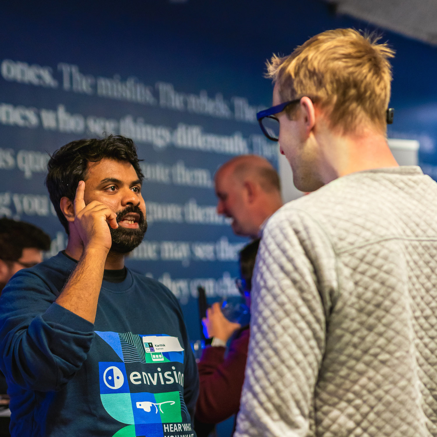 Karthik Kannan showing another person with the Envision Glasses how the gestures work.
