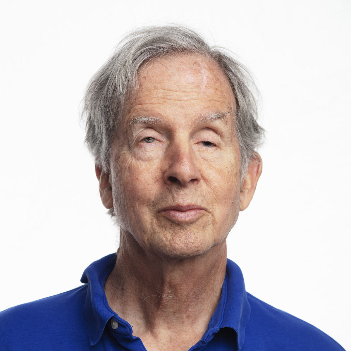 Mike May wears a royal blue short-sleeved polo shirt.