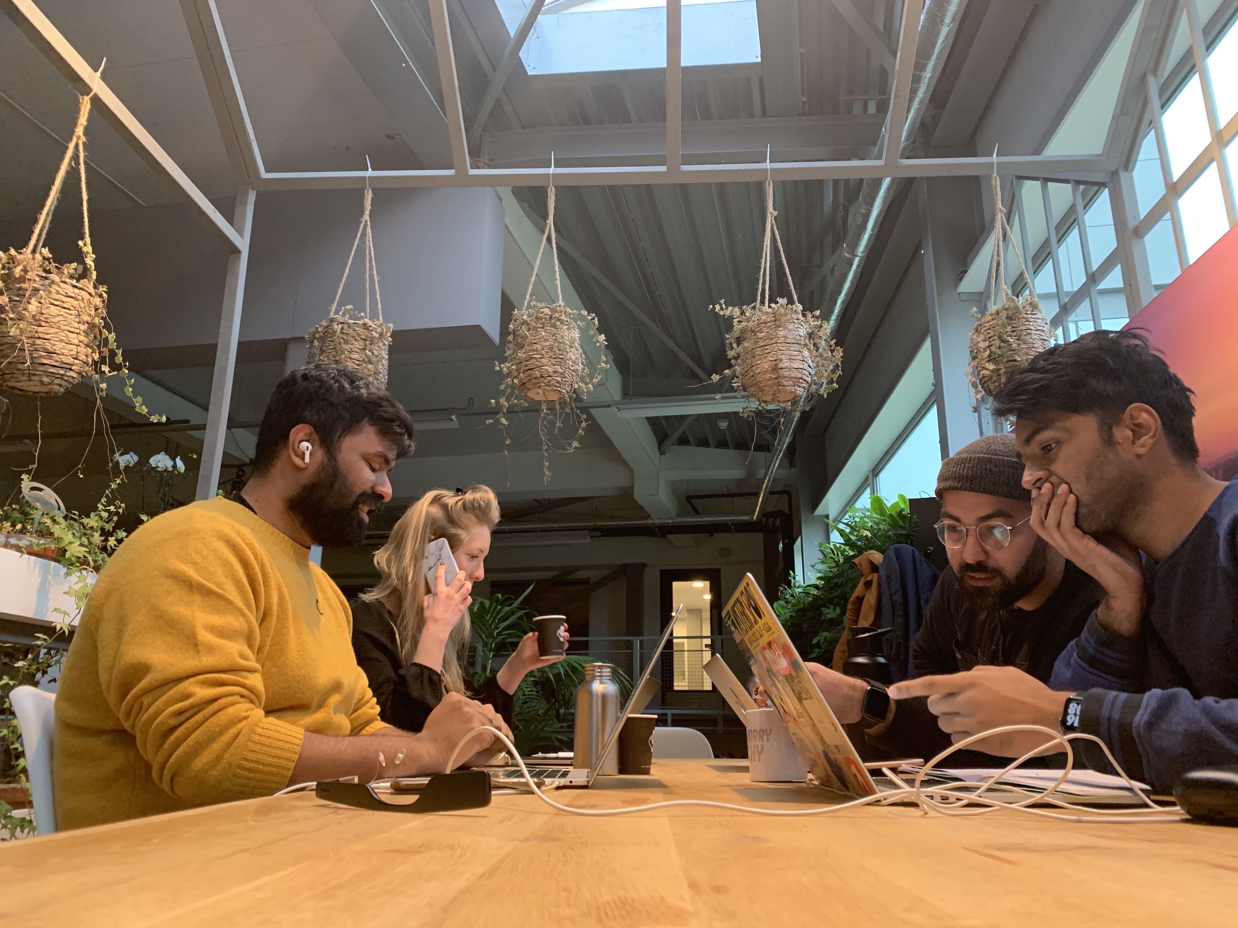 Team Envision sitting on a table while engrossed in their work