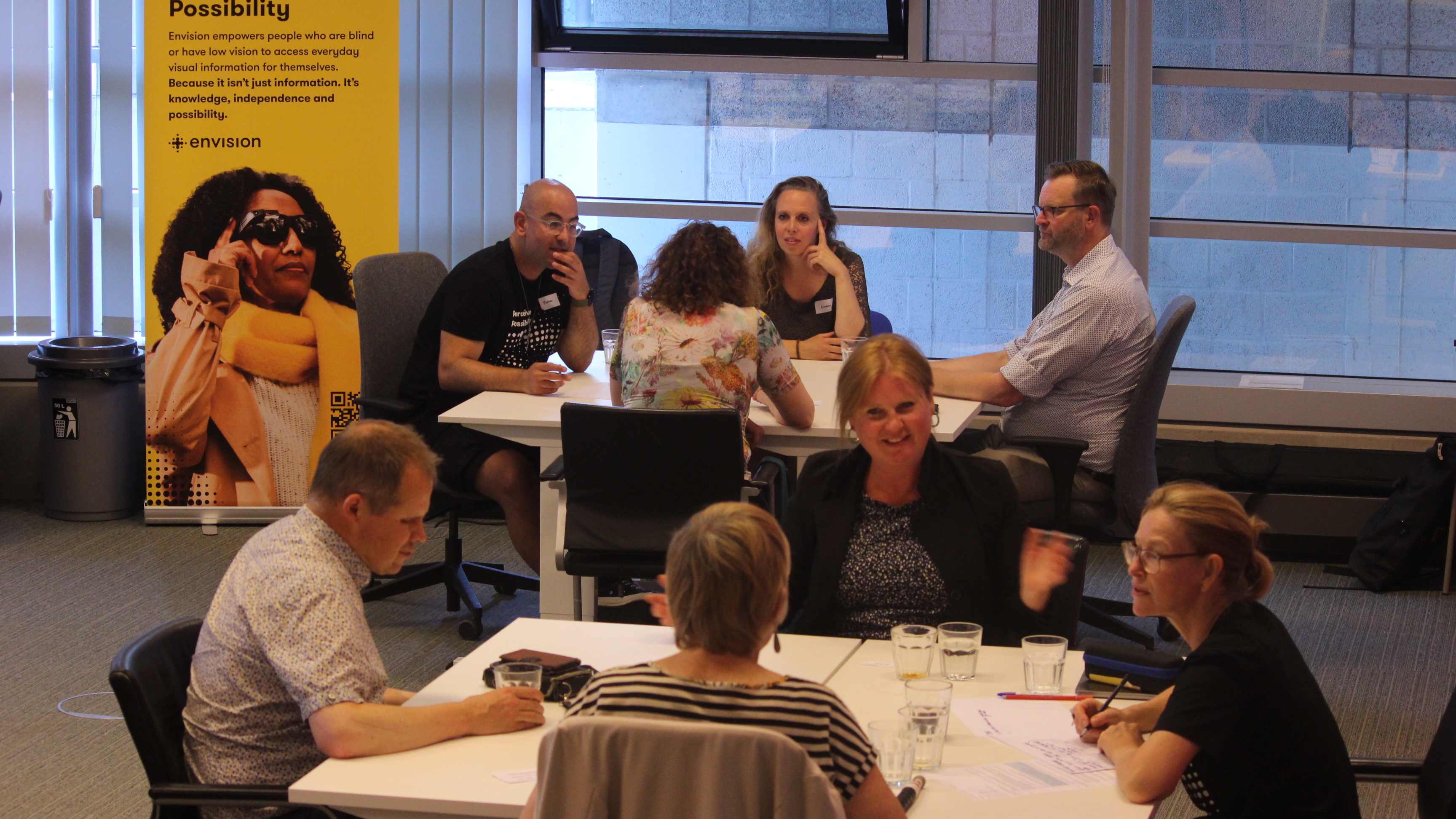 Two tables with different people talking.