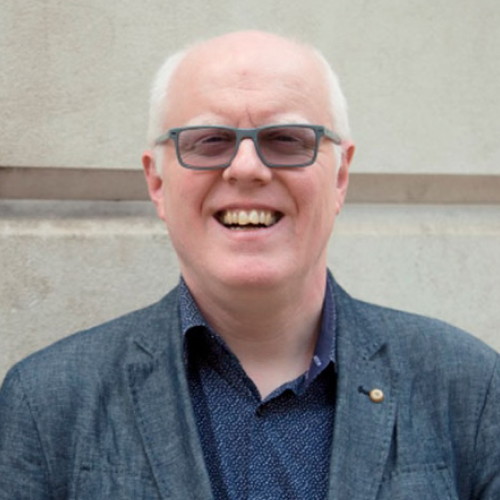 Photo of Robin Spinks wearing a denim blazer and navy shirt