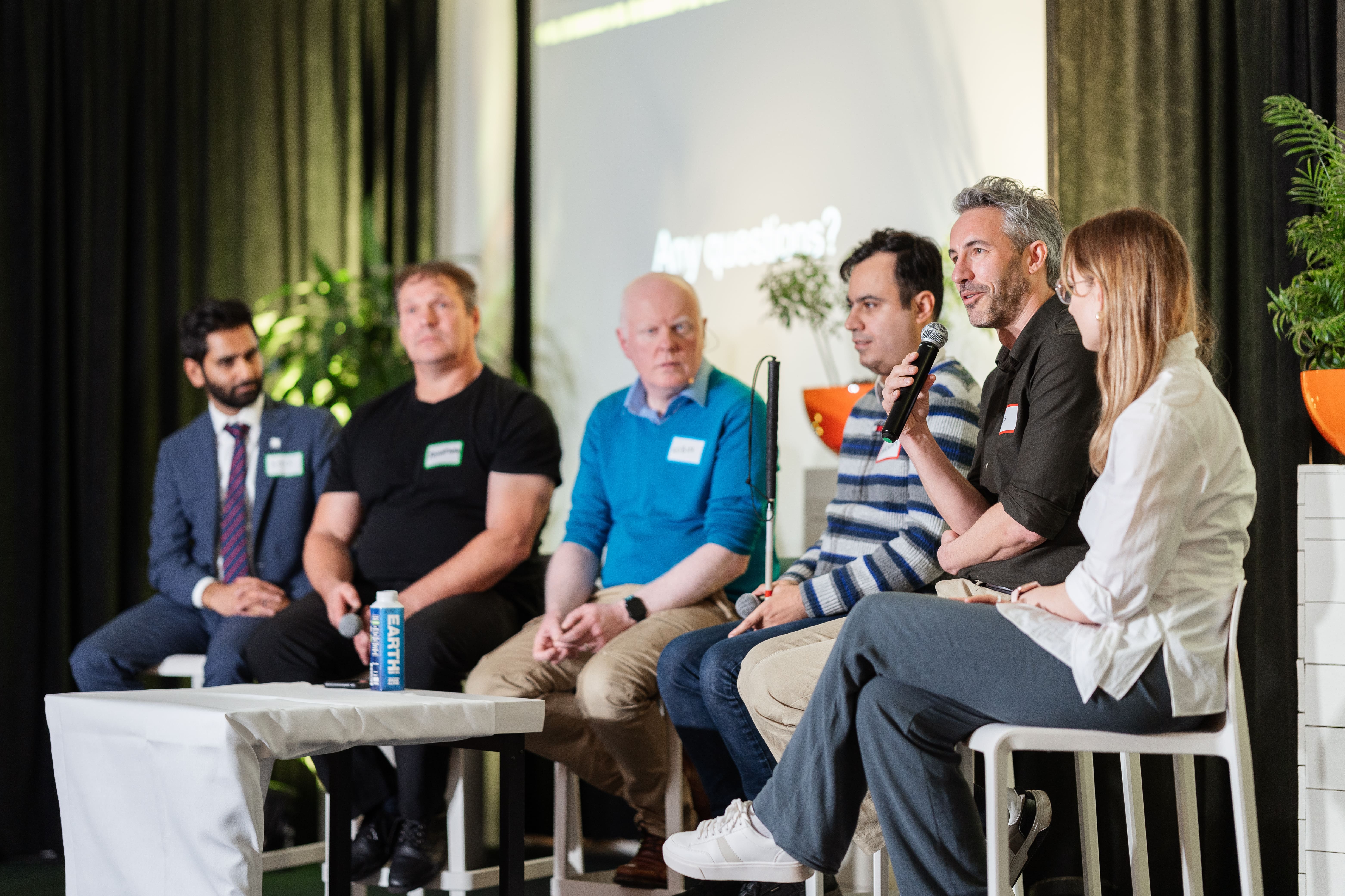 All Panel participants seated while speaking on the ININ stage