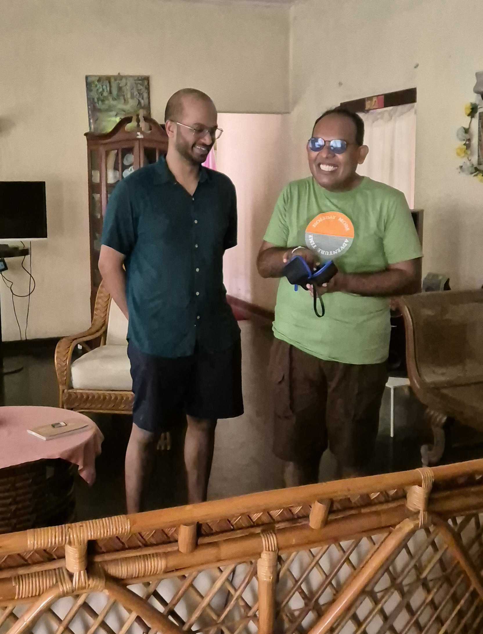 Bhagya and Janitha in his home, Janitha is taking out his Envision Glasses out of the box