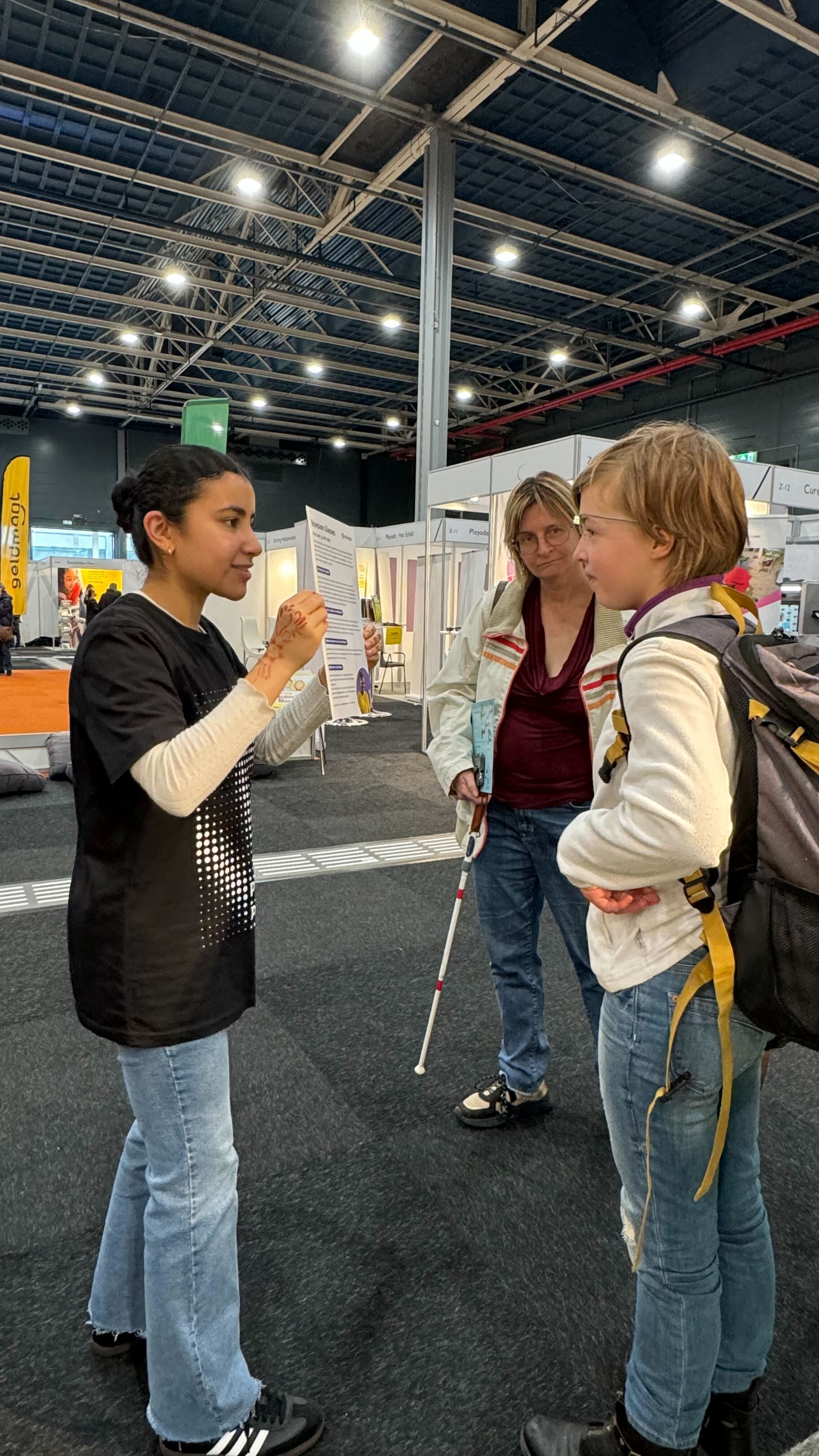 One Envision employee demonstrating the usage of the glasses to a boy during ZaiZo. 