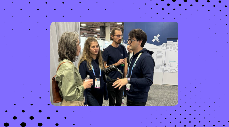 3 dotlumen team members showcasing the dotlumen smart glasses to a female CES visitor