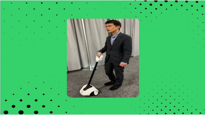 A ces vistor trying the mobility aid. the back ground is green with dots referencing envision's s branding