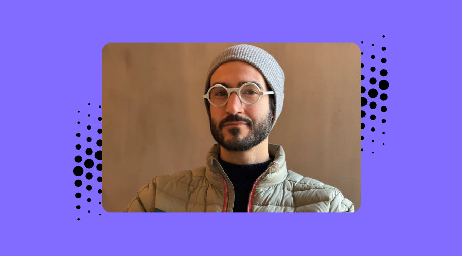 photo of a man wearing the Frame glasses with a purple background
