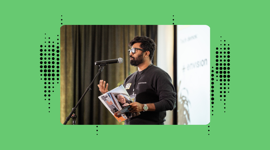 karthik kannan cto at envision, demonstrating ask envision in inclusive innovations event in utrecht. he is holding a dutch magazine